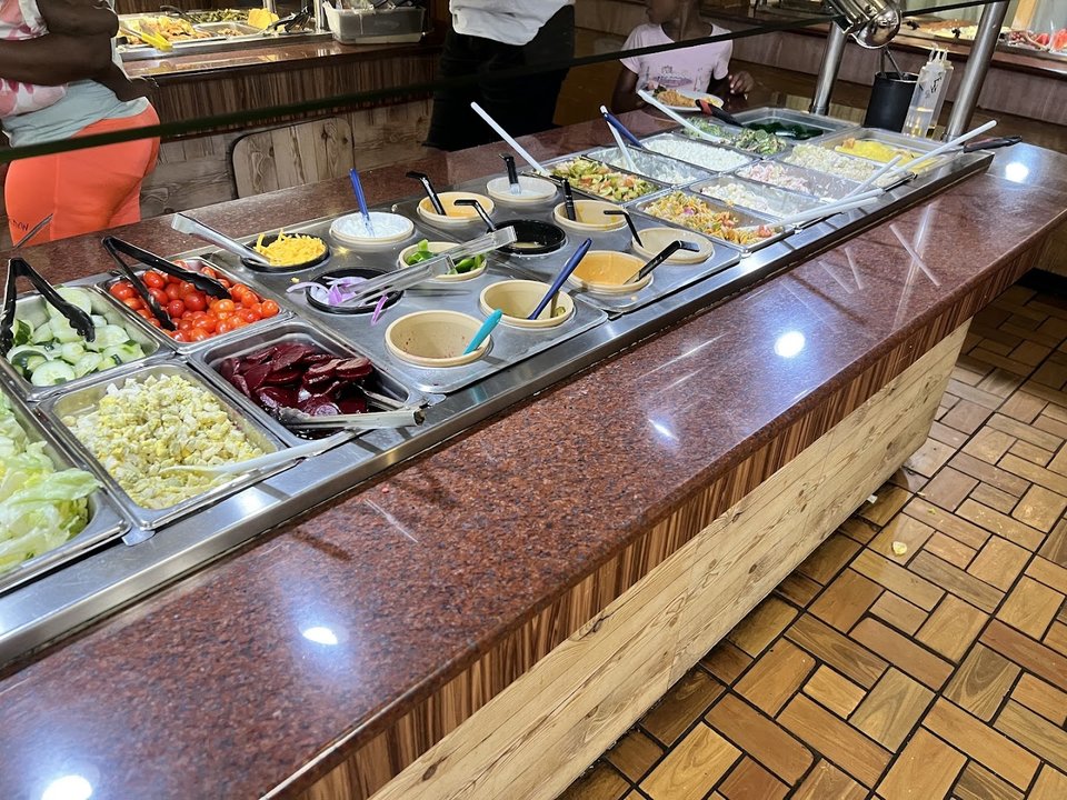 Dessert counter with ice cream and sweet toppings.