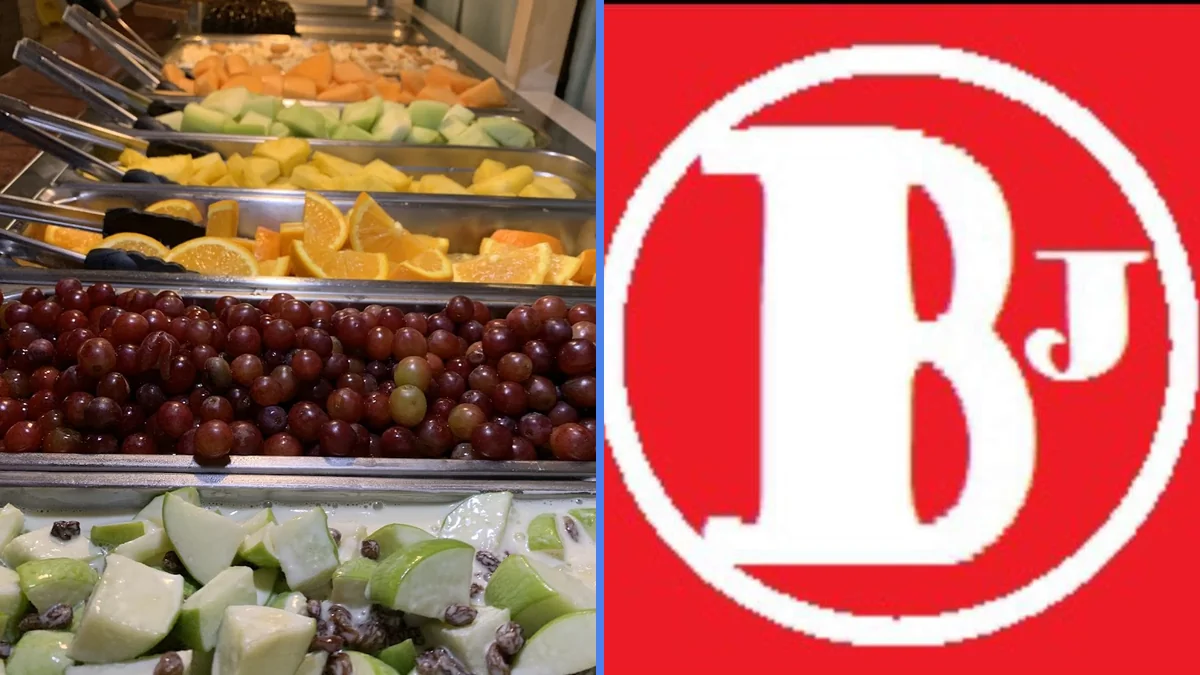 Salad bar with fresh greens and serving spoons.